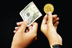 two people exchange money and bitcoin