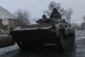 Ukrainian service members ride a BMP-2 infantry fighting vehicle near the frontline town of Bakhmut