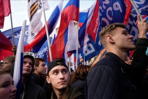 Young Russians hold Russian flags