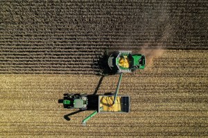 An aerial view of farm equipment harvesting a field