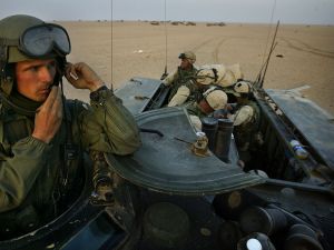 U.S. marines sit on an armoured vehicle during last minute training in the northern Kuwaiti desert near the border with Iraq.