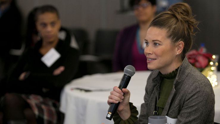 A member of the Emerging Leaders Program asks a question during an event