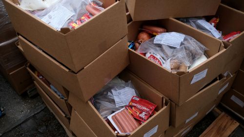 Boxes of food are packed on a pallet waiting to be delivered to families as rural hunger rises due to COVID-19, in Manitowoc, WI