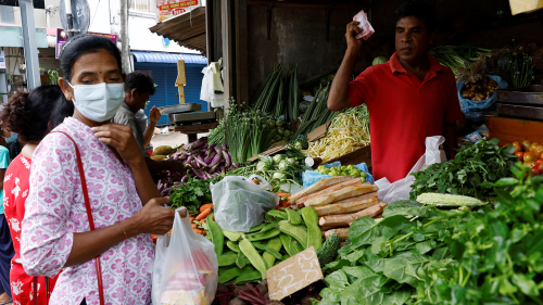 A vendor sells vegetables to a customer amid the rampant food inflation and Sri Lanka's economic crisis in Colombo, Sri Lanka.