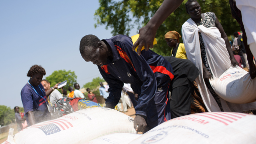 A man holds a sack of food during a food distribution by the World Food Programme (WFP) in Juba, South Sudan. Due to violence against workers, WFP suspended operations in Sudan as of Sunday, April 16.