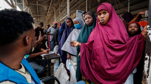 Somali refugees wait to receive food inside a distribution center run by the World Food Programme in Dadaab refugee camp in northern Kenya.