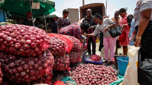 People buy onions at an open market in Nairobi, Kenya. Restrictions on the export of the vegetable by neighboring Tanzania has led prices to triple. 