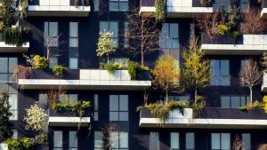 A green building with balcony gardens.