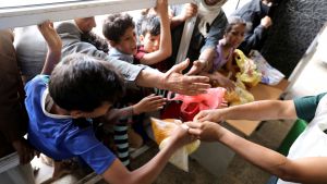 Children waiting for food handouts in Yemen. 