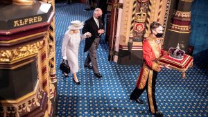 Britain's Queen is escorted out of the House of Lords by Prince Charles behind the imperial state crown during the State Opening of Parliament in London, Britain