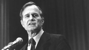 Black and white photo of George H. W. Bush at podium. 