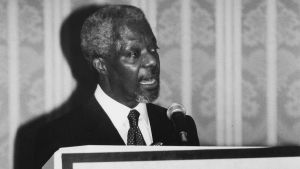 Kofi Annan stands and speaks at a podium