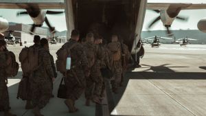 US military men board a plane