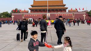 Children playing with flags in Tiananmen Square in Beijing, China