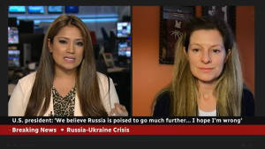 Screenshot of Elizabeth Shackelford speaking on CBC with host about sanctions against Russia.