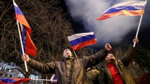 Russian public celebrating after Putin speech in Feb, waving Russian flags.