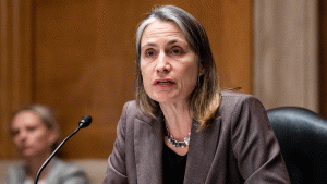 Fiona Hill is seen speaking into a mic at a hearing