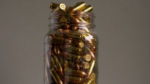 A glass jar full of bullets.