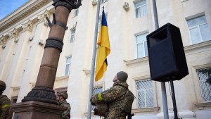 A soldier hoists the State Flag of Ukraine in deoccupied Kherson