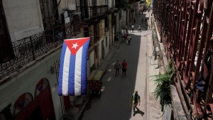 A Cuban flag hangs over a street in downtown Havana, Cuba.