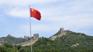 The flag of China flies over the Great Wall of China.