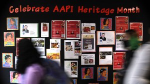 students walk past a display for Asian Pacific American Heritage Month at Farmington High School 