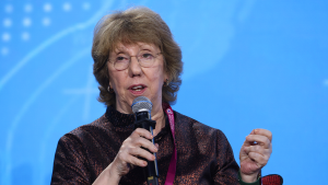 A photo of Catherine Ashton speaking into a microphone.