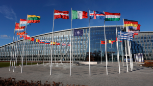Flags wave outside the NATO headquarters.
