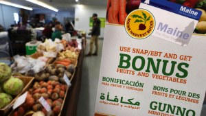 A sign advertises a program that allows food stamp recipients to use their EBT cards to shop at a farmer's market in Topsham, Maine.