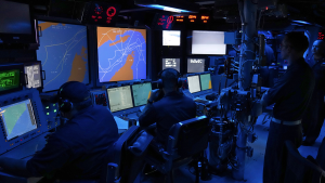 Sailors work at the Combat Information Center of the USS Paul Hamilton in the Strait of Hormuz on May 19, 2023.