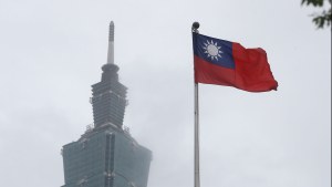 A Taiwan national flag flutters near the Taipei 101 building 