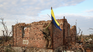 A Ukrainian soldier raises the Ukrainian flag in the village of Andriivka, Donetsk region, Ukraine on September 16, 2023.